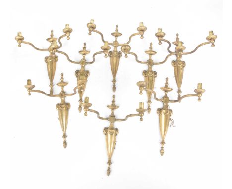 A set of eight early 20th Century Adams style wall mounted brass light fittingsEach cast with a stylised urn above two outswe