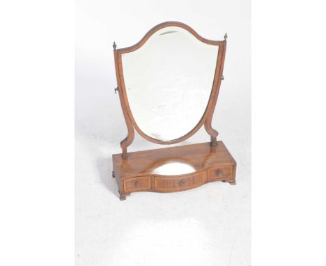 A 19th Century mahogany shield shaped toilet mirrorWith a bevelled plate raised on tapering uprights above a serpentine plint