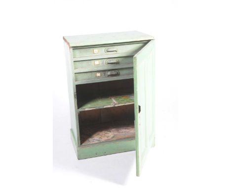 A Victorian painted pine cupboardThe single panelled door enclosing three narrow drawers and a single fixed shelf, raised on 