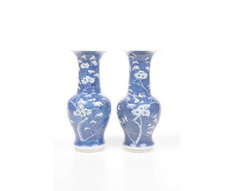 A pair of Chinese blue and white 'Prunus' yen-yen vases, Kangxi four character mark, 19th/20th Century Each of the baluster b