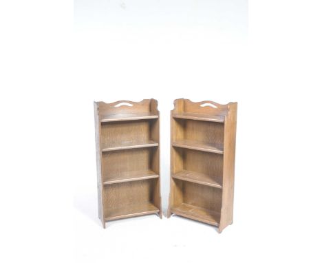 A pair of early 20th Century oak bookcasesFree standing, each with four enclosed shelves raised on bracket supports 54x106x22