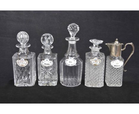 Four assorted glass decanters and a claret jug, mid 20th centuryTo include a bottle shaped example with golf ball stopper and