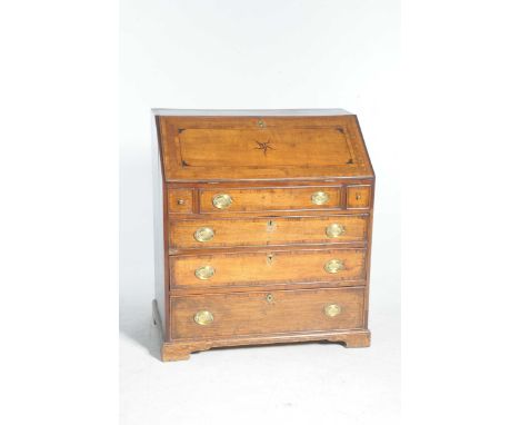 A good George III oak bureauThe rectangular moulded fall front centred with an inlaid star enclosing a sloping and arcaded in