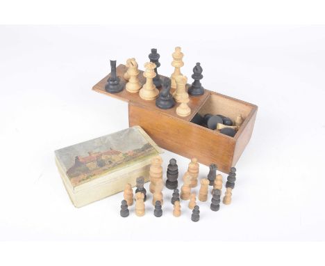 A carved wood chess set/early to mid 20th century Housed in a wooden box, further smaller carved wood chess set. (2) 
