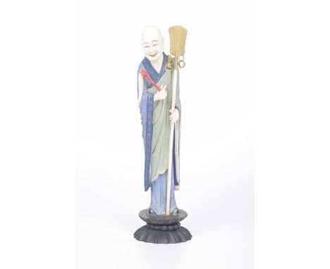 A Chinese carved ivory figure of Luohan, circa 1900The monk dressed in flowing robes, holding a fly whisk and staff with susp