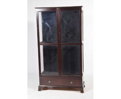 A modern mahogany effect free standing display cabinetHaving two glazed doors enclosing two adjustable glass shelves above a 