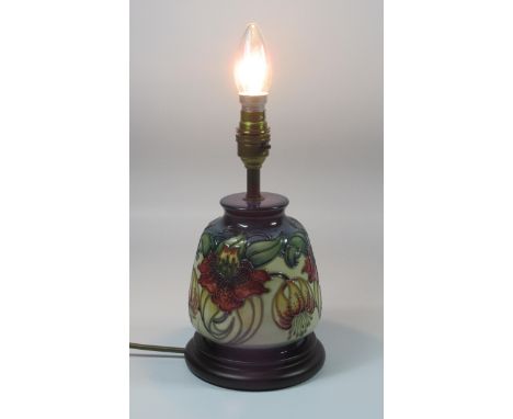 A MOORCROFT POTTERY LAMP BASE, CIRCA 1990'S, OF TAPERING CYLINDRICAL FORM, TUBELINED AND PAINTED WITH THE 'ANNA LILY' PATTERN