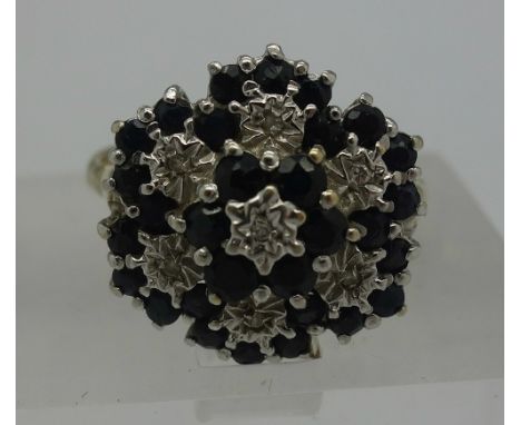 A 9ct gold, diamond and sapphire cluster ring, weight 3.6g, size R