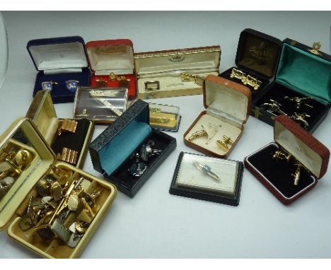 A collection of boxed cufflinks and tie pins