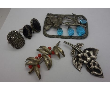 An .830 silver coral brooch, a white metal ring, a silver Arts and Crafts brooch, a blue stone brooch and two sterling silver