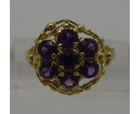 An 18ct gold purple stone cluster ring, weight 3.9g, size O