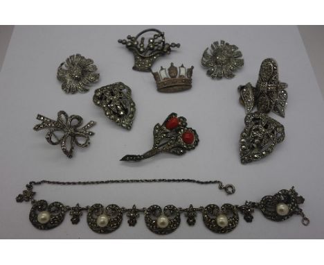An .800 silver and coral brooch, a .830 silver necklace, three silver brooches, two pairs of silver marcasite earrings, silve