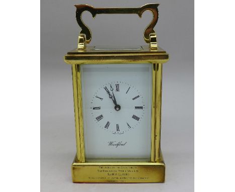 A brass cased carriage clock, Woodford, made in England, with inscription, height 11.5cm