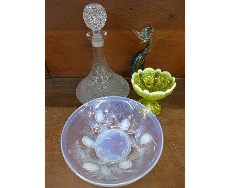 A uranium glass bowl, a vaseline glass bowl, a glass model of a duck and a ship's decanter