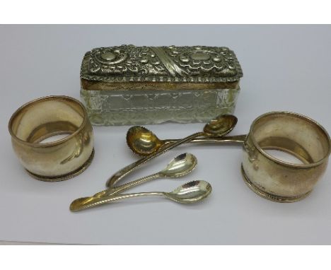 A silver topped trinket box, two silver napkin rings and four plated spoons, weight of silver 51g