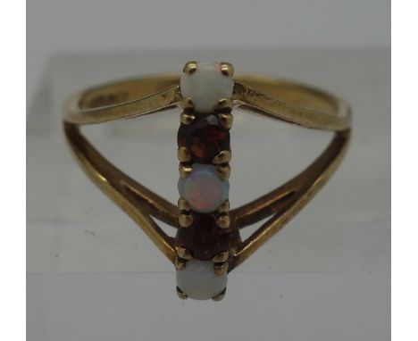 A 9ct gold, opal and red stone ring, weight 2.8g, size O
