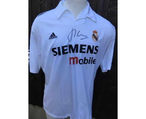 Figo Real Madrid Signed Football Shirt: Clearly signed to front with photo of him signing whilst at Old Trafford in 2003.