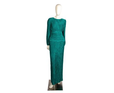 Turquoise crimped polyester, banded waist evening dress. Open back with zipper closure and large satin bow with rhinestone en