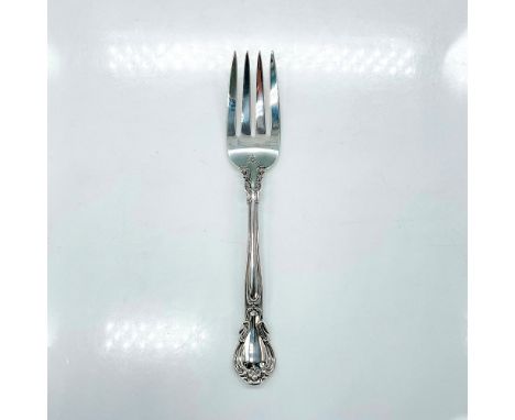 Sterling silver serving fork with an elegant scroll and fleur-de-lis accent design. Stamped Gorham Sterling. Dimensions: 8.25