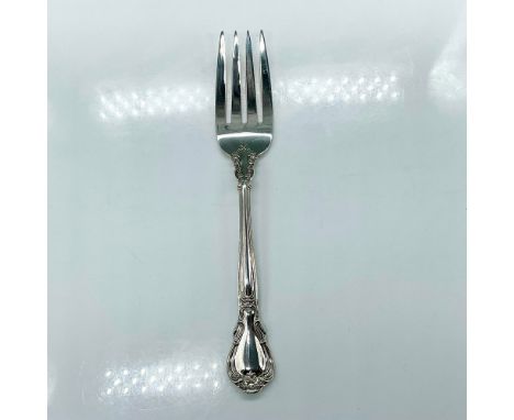 Sterling silver serving fork with an elegant scroll and fleur-de-lis accent design. Stamped Gorham Sterling. Dimensions: 8.5"
