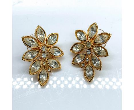 Gold metal with clear marquise cut rhinestones forming a floral motif. Monet mark on back. Dimensions: 1.25"L x 0.75"WManufac