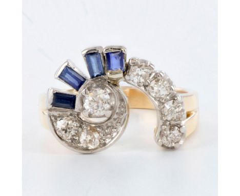 The ring features 7 old mine-cut diamonds and 4 baguette-cut sapphires weighing 0.75ctw combined. The stones are set in a whi