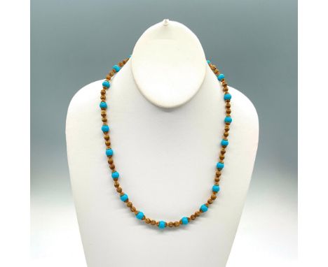 Nice necklace with gold tone and light blue beads and a spring ring clasp. Dimensions: 21.25"LCondition: Age related wear.