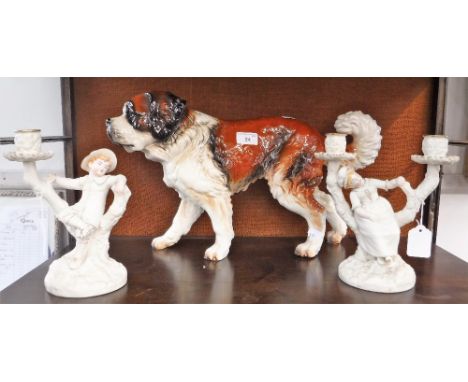 A GOEBEL "ST BERNARD" DOG, 11" high (approx) x 18" long and a pair of Royal Worcester blush ivory candlesticks, each decorate