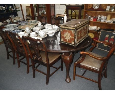 AN EDWARDIAN MAHOGANY DINING SUITE, comprising; a set of eight Chippendale Revival chairs, with green leather drop-in seats, 