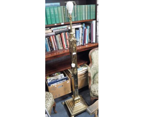 AN EDWARDIAN BRASS STANDARD LAMP on hairy paw feet, 141 cm high (to top of fitting)