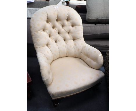 A VICTORIAN BUTTON-BACK ARMCHAIR, upholstered in cream material on walnut cabriole legs