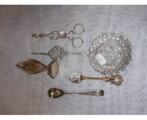 A STERLING SILVER PEPPERPOT, a silver mustard spoon, tongs, an enamelled spoon and a Continental decorative ladle (a lot)