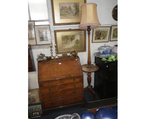 A FIGURED WALNUT BUREAU and a standard lamp