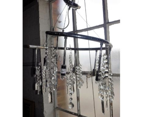 A CONTEMPORARY CHROME CHANDELIER with cut glass droplets 