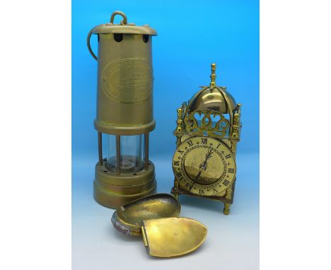 A British Coal Mining brass miner's lamp, a brass snuff box and a Smith's lantern clock with battery movement