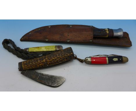 A woodcraft knife with scabbard and three pocket knives