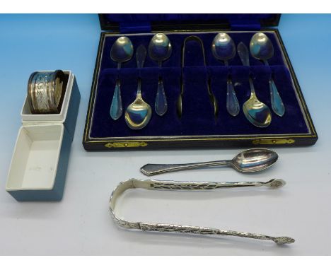 A pair of silver sugar bows, a silver napkin ring and a set of plated spoons, 50g silver