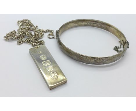 A silver ingot pendant and chain and a silver bangle, 80g