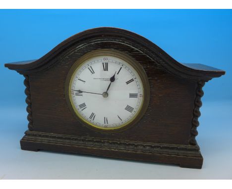 A wooden mantel clock, the dial marked Sheffield Goldsmiths Co. Ltd.