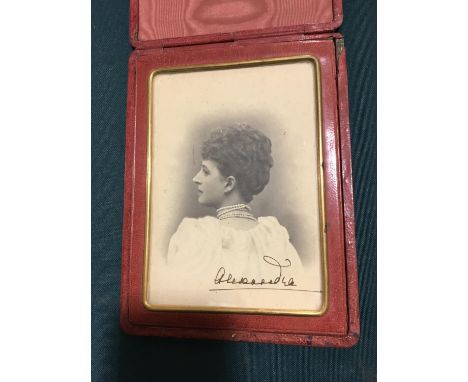 Alexandra, Queen of Edward VII of England. Portrait photograph in profile, signed 'Alexandra', in folding cerise leather case