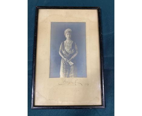 Mary, Queen of George V of England. A formal portrait photograph, three-quarter length, wearing a tiara and holding a fan, si