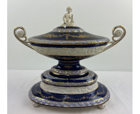 A large Continental ceramic centrepiece lidded tureen with cobalt blue banded glaze and bisque cherub finial. 2 handled oval 
