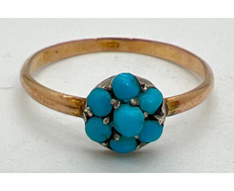 A vintage 9ct rose gold and turquoise dress ring. Small round cabochon of blue turquoise surrounded by 6 smaller round turquo