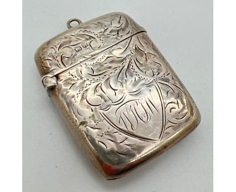 An ornately engraved Edwardian silver vesta case with scroll &amp; foliate detail and engraved initials to shield shaped cart