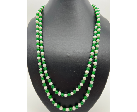 A 48" string of alternate green jade and freshwater pearl beads. Each bead approx. 6mm diameter. 
