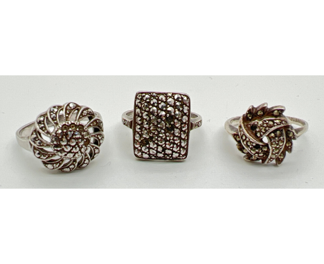 3 vintage silver dress rings each set with marcasite stones, in various designs to include square and floral. (stones missing