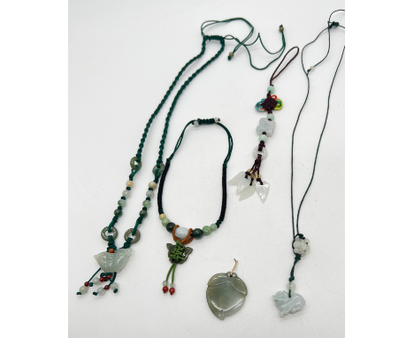 4 items of corded jade jewellery together with a jade and coloured cord bag charm. A necklace with carved jade butterfly, rou