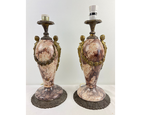 A pair of heavy 19th century French marble and cast metal urn style table lamps. Cherub and swag metal detail to bodies with 