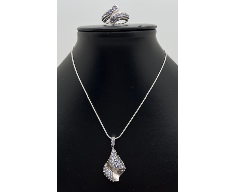 A silver modern twist deign pendant necklace and matching ring, both set with round cut pale lilac stones. Chain length appro