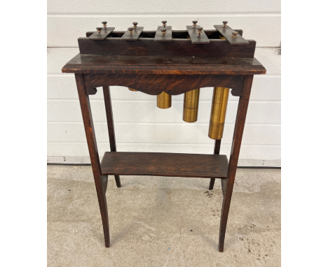 A vintage 1920's brass and dark oak marimbaphone/glockenspiel raised on slim square legs with curved feet. Approx. 75cm tall 